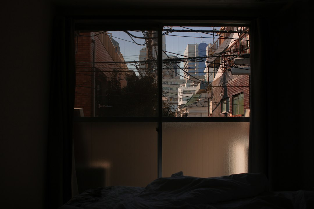 Bedroom overlooking a city at night, illustrating environmental noise and sleep